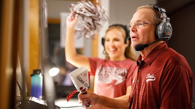 Two people cheering for sports team