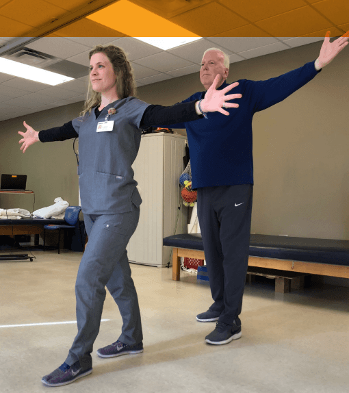 Nurse helping patient with physical therapy