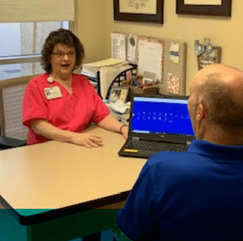 Nurse and patient at a desk