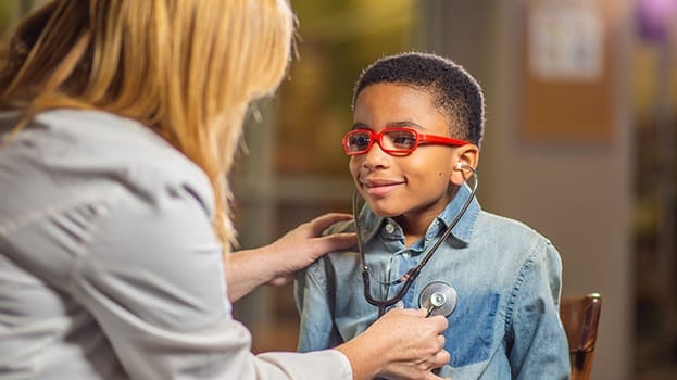 Kid with glasses getting heart checked