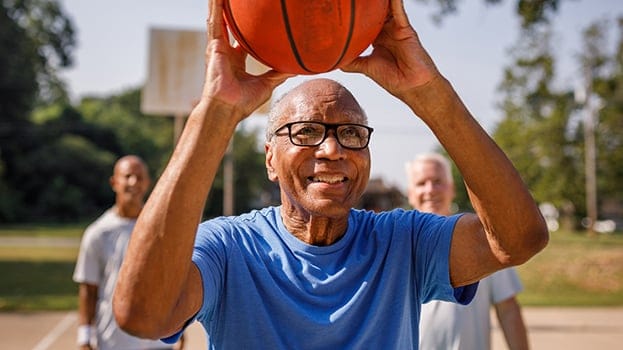 Older man playing basketball